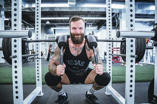 human men's black tank top and black shorts exercise