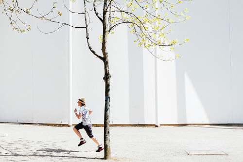 human person in white T-shirt running shorts