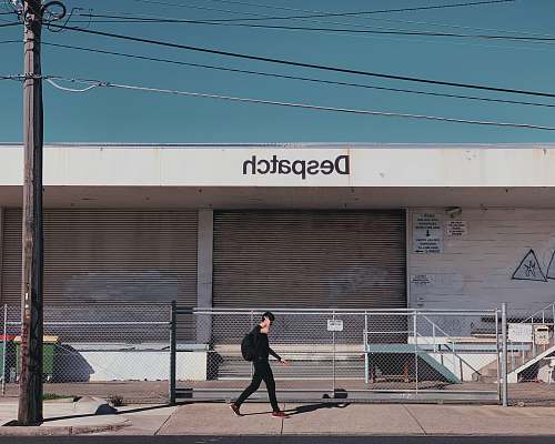 human person walking in front of store grey