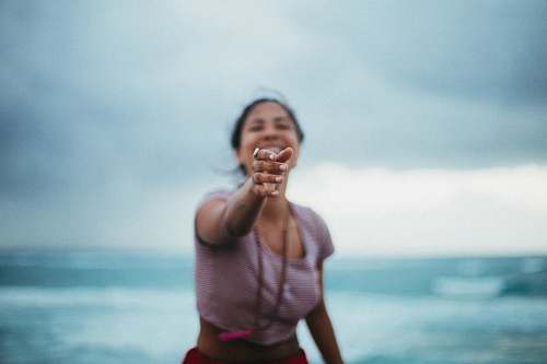 people selective focus photo of woman standing near beach human