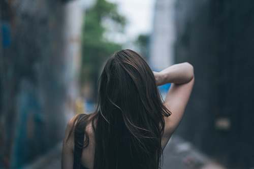 girl selective focus photography of woman waving her hair hair