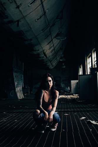 human woman crouching on ground people