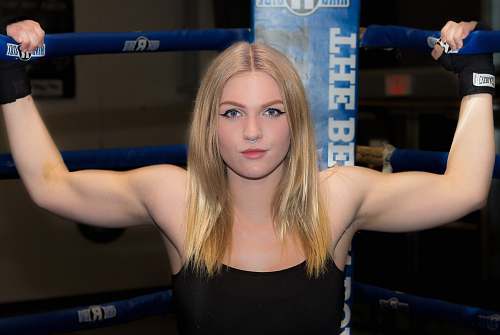 human woman gripping boxing rink with both hand sport