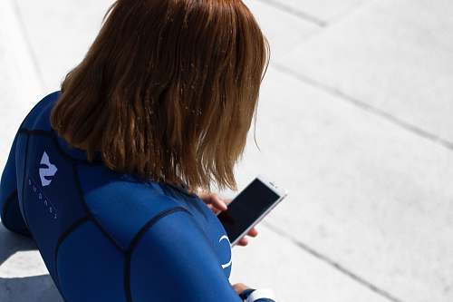 human woman holding smartphone during daytime people