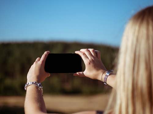 human woman holding smartphone people