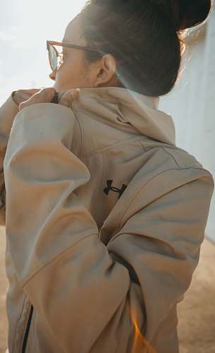 clothing woman in beige Under Armour jacket during daytime apparel