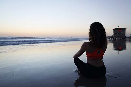 human woman seated on shore sport