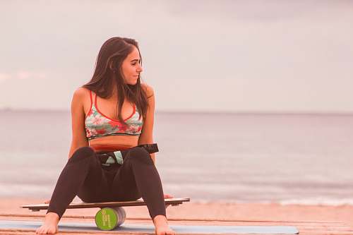 human woman sitting on board balancing on canister female