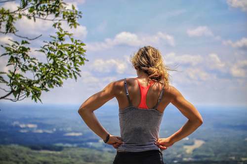 human woman standing near tree looking below people