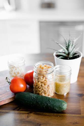 food green cucumber near jars on table vegetable