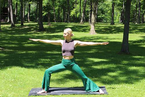 human woman doing yoga grass