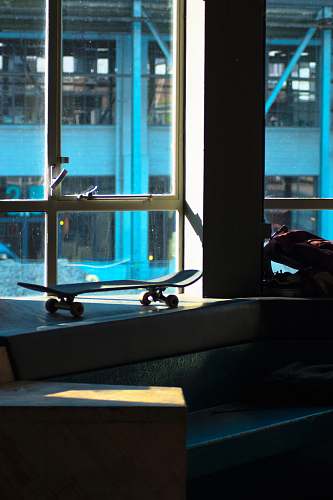 sport skateboard beside glass window sports