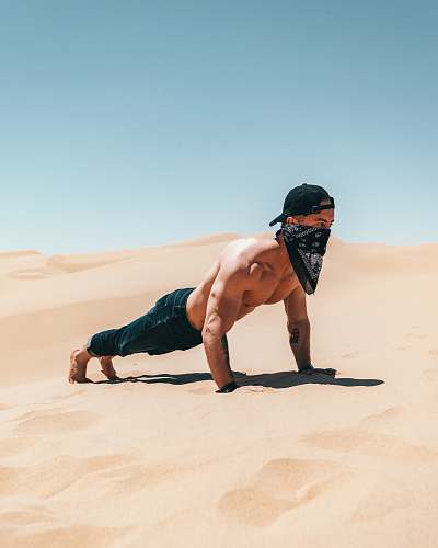 sand man pushing up on dessert nature