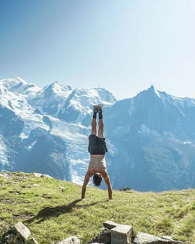 fitness man doing yoga on hill human