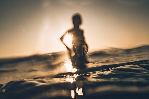 fitness silhouette of person standing on sea wave during daytime exercise