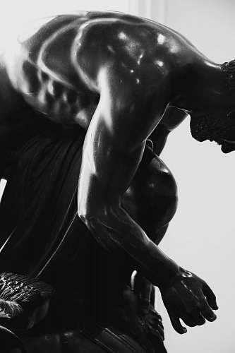black-and-white sitting man working out
