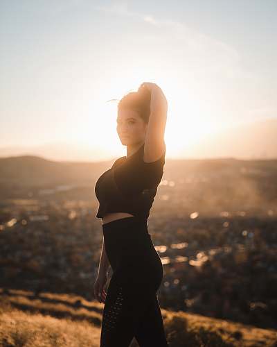 human woman holding hair during daytime person