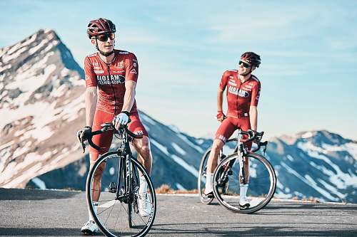 vehicle two men biking on road viewing mountain bicycle