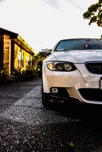 automobile white vehicle parked near house car
