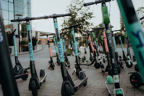 transportation electric scooters parked on sidewalk machine