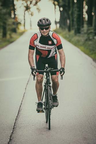 bike man riding road bike on concrete road during daytime bicycle