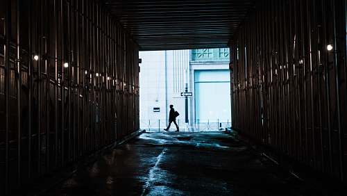 manhattan person walking in front of tunnel new york