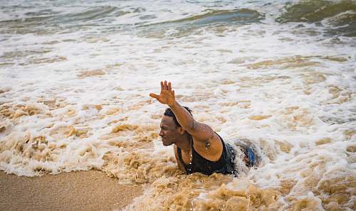 nature man swimming on beach during daytime ocean