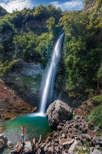 outdoors waterfalls surrounded by trees and rocks waterfall