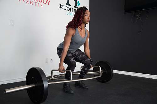 human woman about to lift barbell person